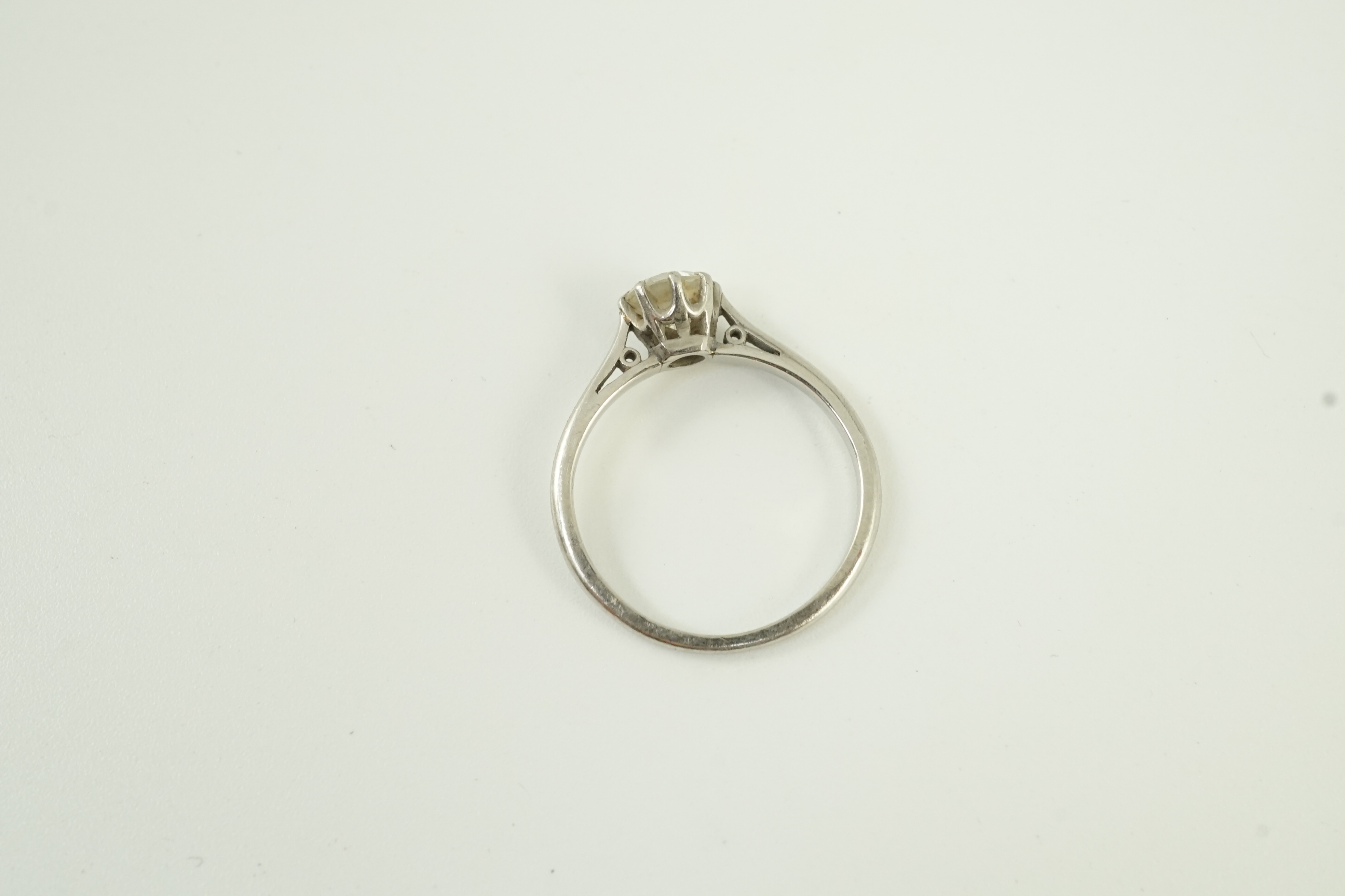 A white metal (stamped plat) and solitaire diamond set ring, size K, gross weight 2.6 grams